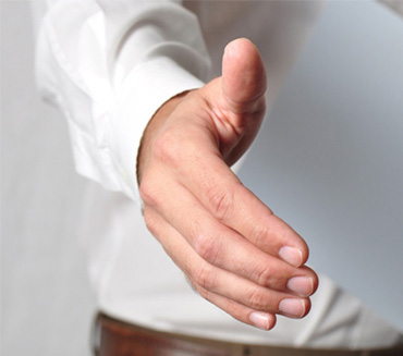 Hands signing a contract document